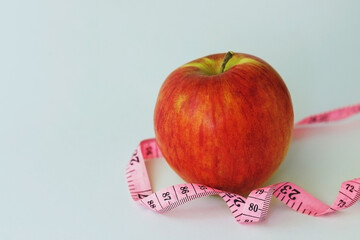 red apple with measuring tape