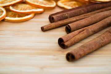 Cinnamon sticks and dried slices of orange close up, shallow depth of field, low angle view