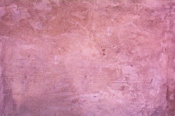 Old red wall in spots, cracks, stains. Painted concrete wall in abstract grunge style loft. Vintage wall background texture for backgrounds, portraits, posters.