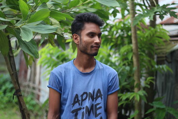 A boy is standing upset and his behind the background blur