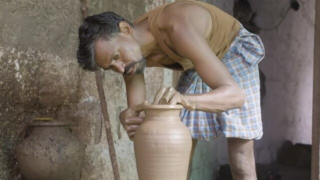 Concentrated Indian Potter Artist Making Clay Pot Or On Traditional Cart Wheel - Concep Of Handcraft Work, Poverty, Traditional Culture And Local Artwork.