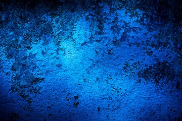 Old blue wall in spots, cracks, stains. Painted concrete wall in abstract grunge style loft. Vintage wall background texture for backgrounds, portraits, posters.