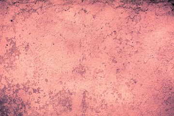 Old red wall in spots, cracks, stains. Painted concrete wall in abstract grunge style loft. Vintage wall background texture for backgrounds, portraits, posters.