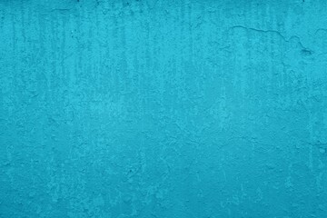 Old blue wall in spots, cracks, stains. Painted concrete wall in abstract grunge style loft. Vintage wall background texture for backgrounds, portraits, posters.
