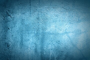 Old blue wall in spots, cracks, stains. Painted concrete wall in abstract grunge style loft. Vintage wall background texture for backgrounds, portraits, posters.