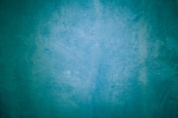 Old blue wall in spots, cracks, stains. Painted concrete wall in abstract grunge style loft. Vintage wall background texture for backgrounds, portraits, posters.