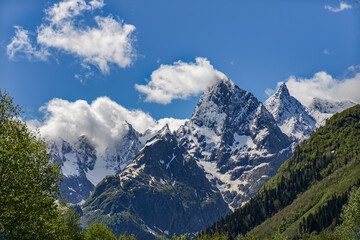 Fototapeta na wymiar Chotcha Mountain Peak Covered with Snow in Teberda Nature Reserve on Clear Sunny Day