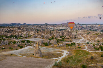 Cappadocia, Turkey - September 1, 2021 - Cappadocia Panoramic - Hot air balloon flying in early...