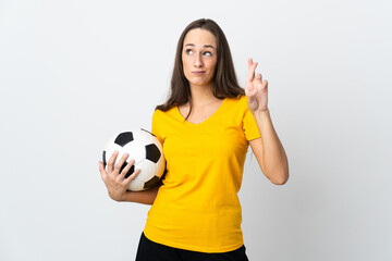 Young football player woman over isolated white background with fingers crossing and wishing the best