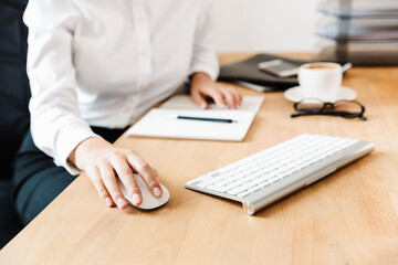 Happy mid aged businesswoman at the desk