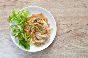 fried Udon yakisoba Japanese noodles slice pork bacon and cabbage with carrot on bowl
