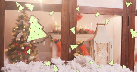 Digital image of multiple christmas tree icons falling against wooden window frame