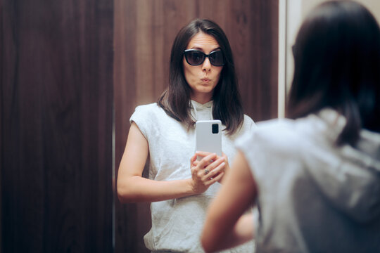 Woman Trying on Outfit Taking a Selfie in a Changing Room Mirror