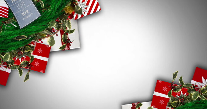 Digital image of christmas decorations and gifts against grey background