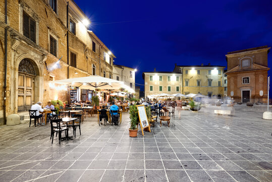 Montefalco Umbria Italy. Piazza del Comune at sunset. People eating out