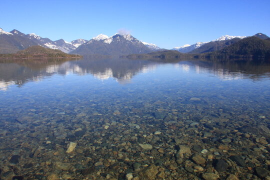 Snow capped mountains and a clear lake on Vancouver Island, British Columbia (BC), Canada