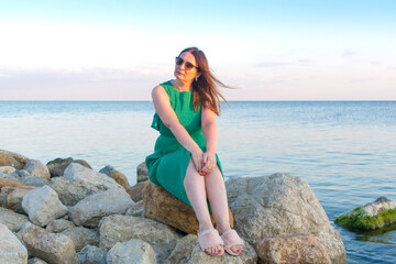 Russia, Crimea, Feodosia, Primorsky village, August 20, 2020. Attractive woman in sunglasses against the background of the Black Sea.