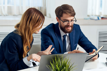 business man and woman work together in front of laptop office technology