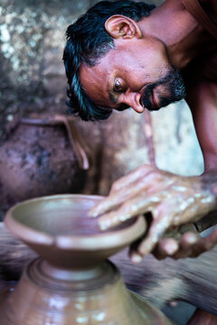 Concentrated Indian Potter Artist Making Clay Pot Or On Traditional Cart Wheel - Concep Of Handcraft Work, Poverty, Traditional Culture And Local Artwork.