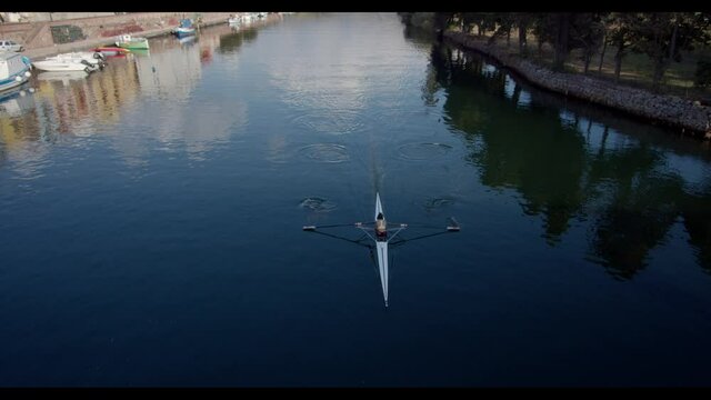 An aerial view of a woman on a rowing boat in Alabe, Sardegna