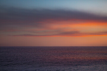 Naklejka na ściany i meble Sunset over the sea with a beautiful sky