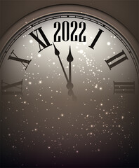 Fototapeta na wymiar Clock showing 2022 with sparkling snow.