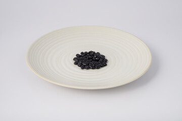 Fototapeta na wymiar Black Beans on a plate on white background