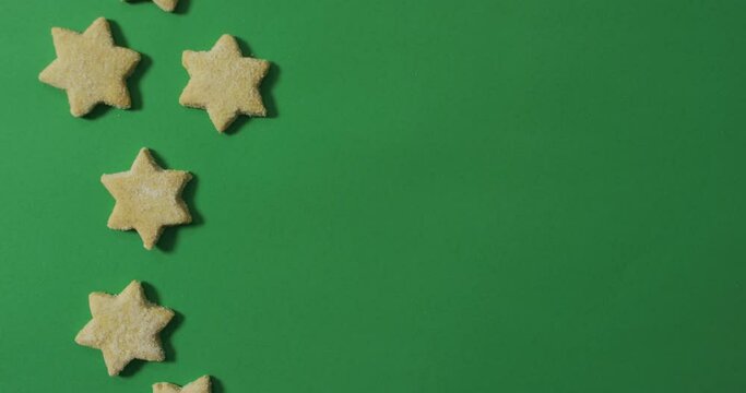 Star shaped christmas cookies and copy space on green background