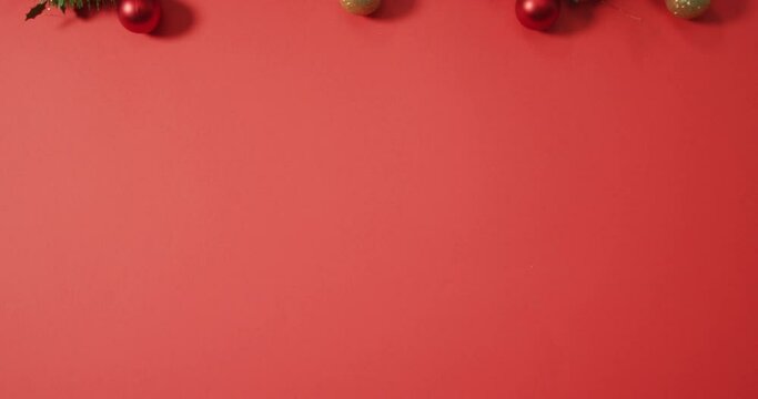 Christmas decorations with baubles and copy space on red background