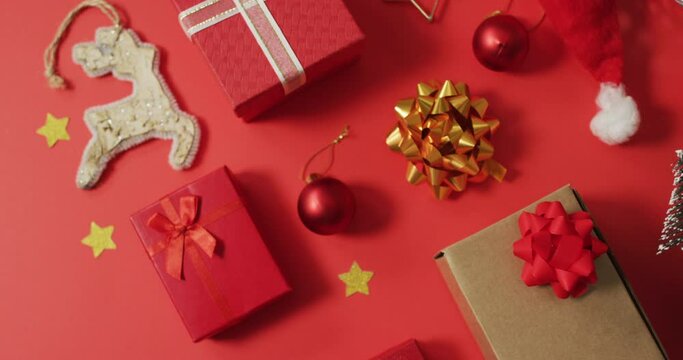 Christmas decorations with presents and copy space on red background