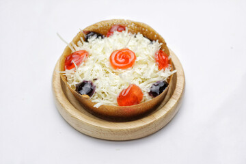 Martabak Mini or Martabak Mini Bangka with various Topping. The martabak mini bangka is made from a mixture of flour, eggs, sugar, baking soda, coconut milk and water.