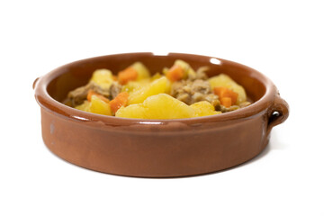 Potato stew with beef, a food widely consumed in Spain. Isolated on white. Selective focus, copy space