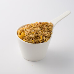 white dish cup full of yellow cereal