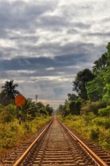 Railway track with cloudy sky