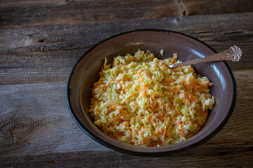 Coleslaw on wooden table