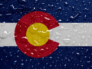 flag of Colorado, USA with rain drops