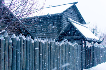 Russia, Tula. January 9, 2021. Village with wooden houses and a fence in winter.