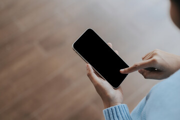 Close up of women's hands holding cell telephone with blank copy space scree for your advertising text message or promotional content