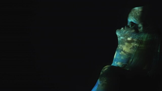 Sensual woman. Female grace. Night euphoria. Psychedelic drug. Wasted carefree lady dancing in colorful double exposure hallucinogenic blue green universe on dark copy space.