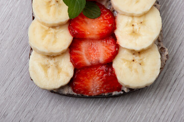 Vegetarian whole grain toast with strawberry and banana. Healthy food concept. Close-up, selective focus