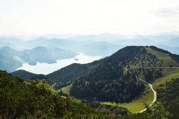 Fototapeta na wymiar GERMANY, MUNCHEN: Scenic landscape aerial view of Bavarian Alp mountains with lake in the valley 