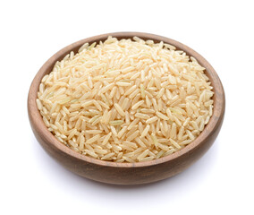 close up of uncooked long brown rice in the wooden plate, isolated on white