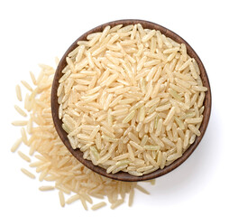 uncooked brown rice in the wooden bowl, isolated on the white background, top view