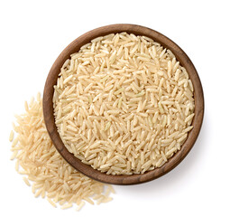 uncooked brown rice in the wooden bowl, isolated on the white background, top view