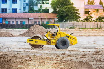Vibratory soil compactor working on highway construction site