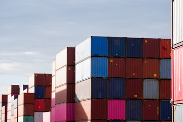 Fototapeta premium Freight, transportation, transportation, transportation, delivery and distribution. commercial business ideas Group of 40-foot heavy-duty colored metal containers stacked in the wharf.