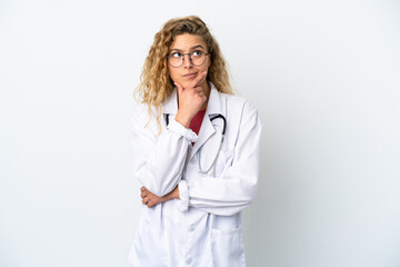 Young doctor blonde woman isolated on white background having doubts