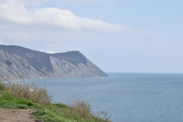View of the Black Sea, beach and mountains. The resort town of Anapa. Russia. Photo taken in spring.