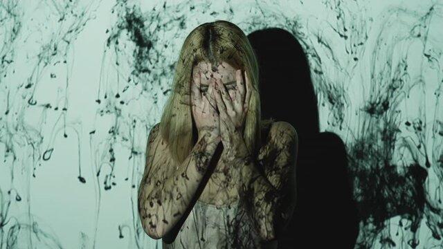 Crying woman. Female abuse. Depression despair. Family loss. Frustrated stressed lady victim hands covering face in black ink drops double exposure isolated on light free space.