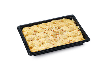 Black plastic box of Turkish halva dessert isolated on white